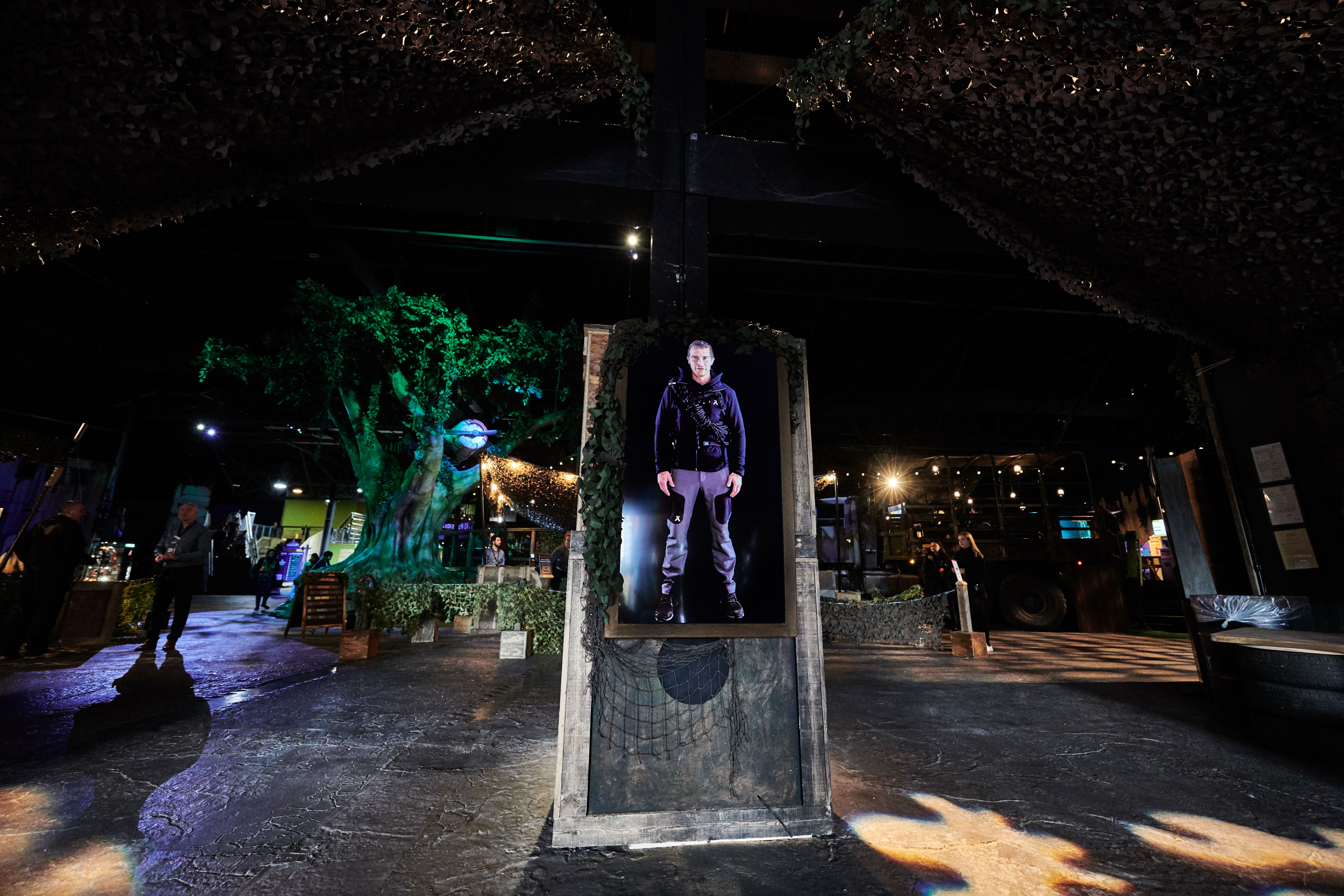 Bear Grylls welcomes guest on a screen in The Bear Grylls Adventure main entrance